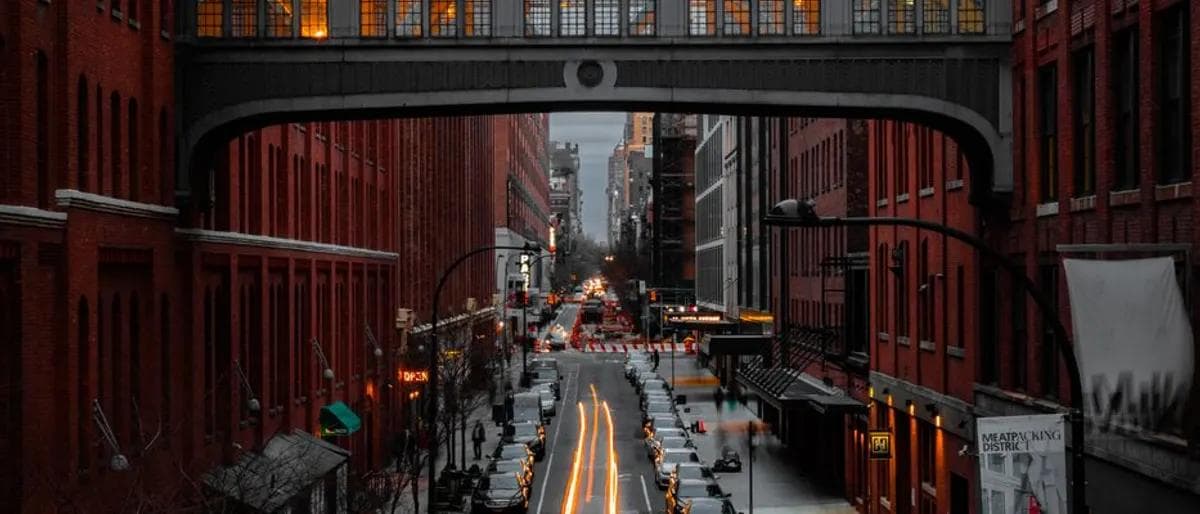 The High Line footbridge arching over a Chelsea street in Manhattan at golden hour